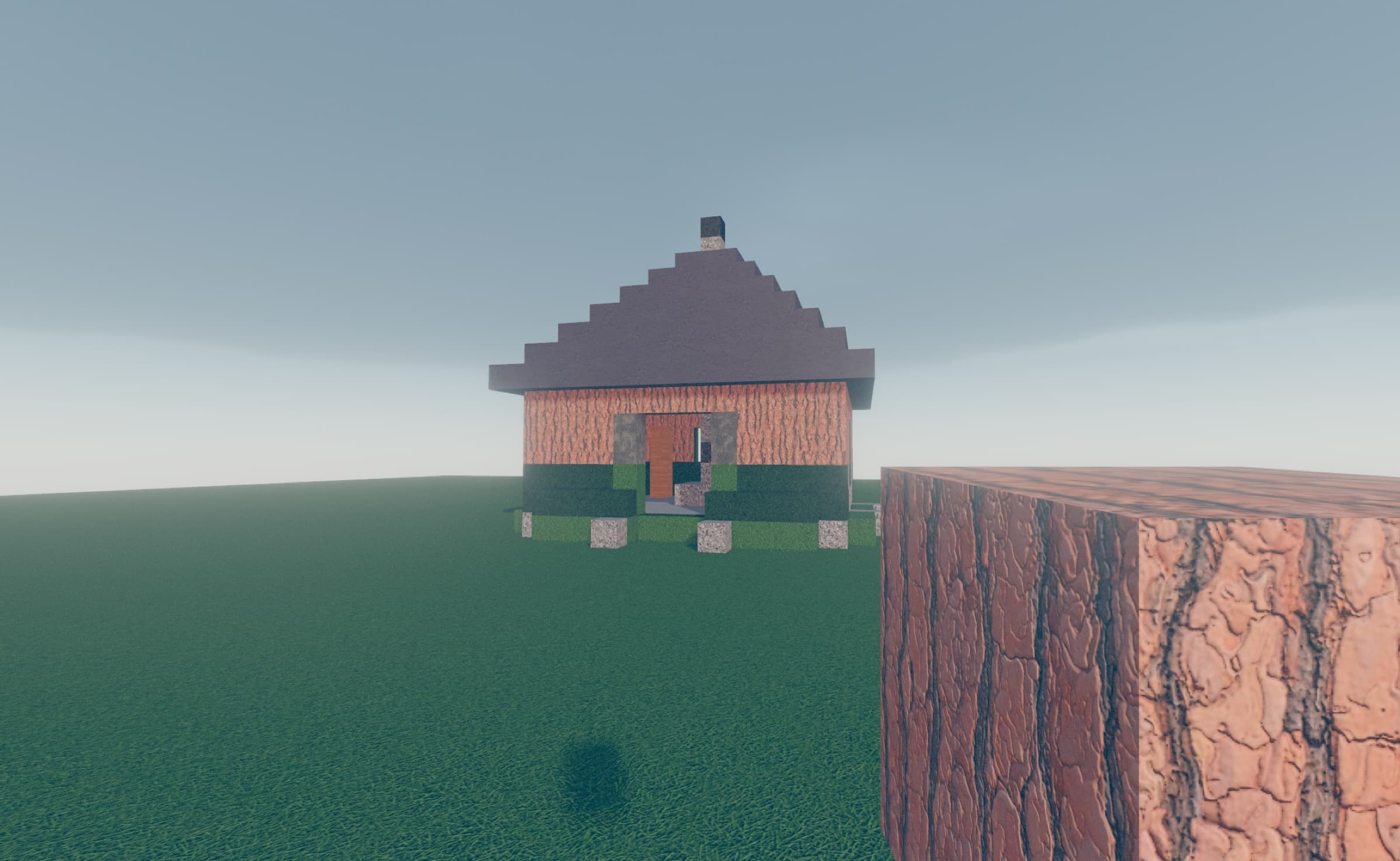 A voxel cottage at the edge of a green cliff, built inside Zero.